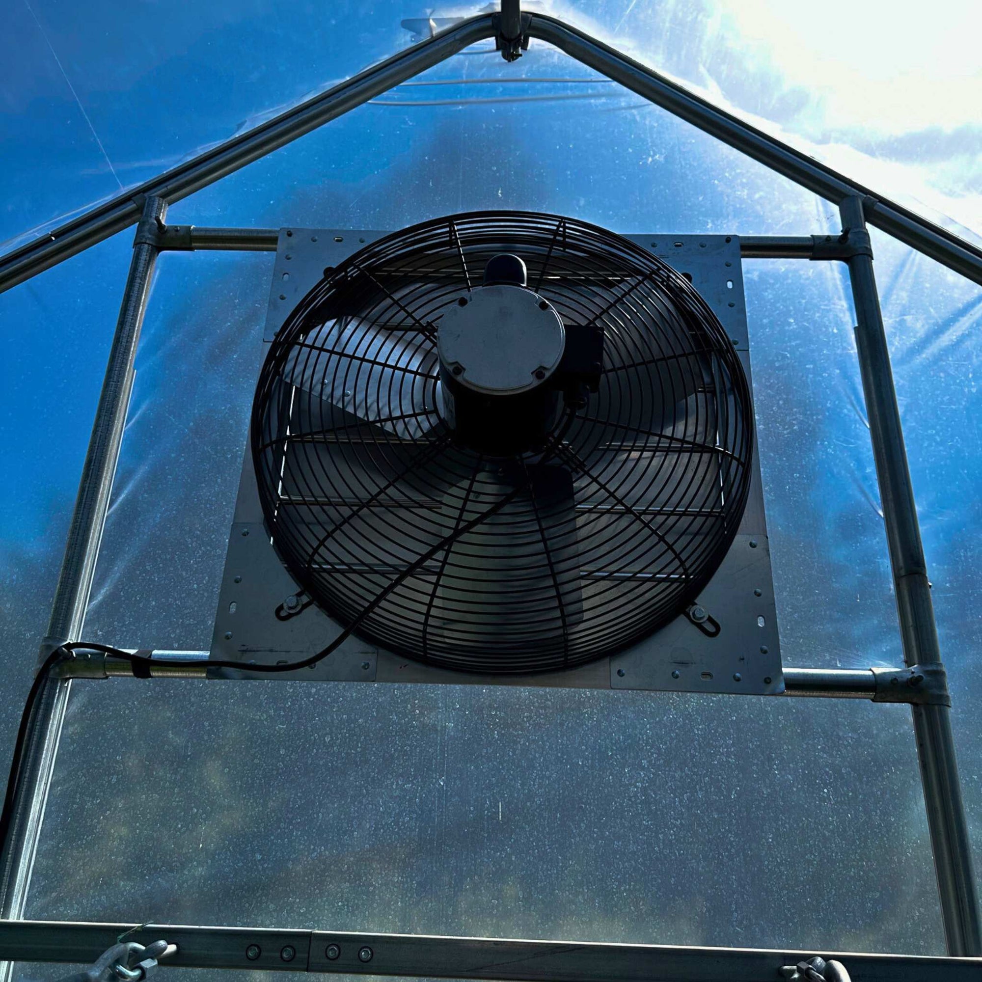 Shutter Exhaust Fan installed on gothic peak hoop house
