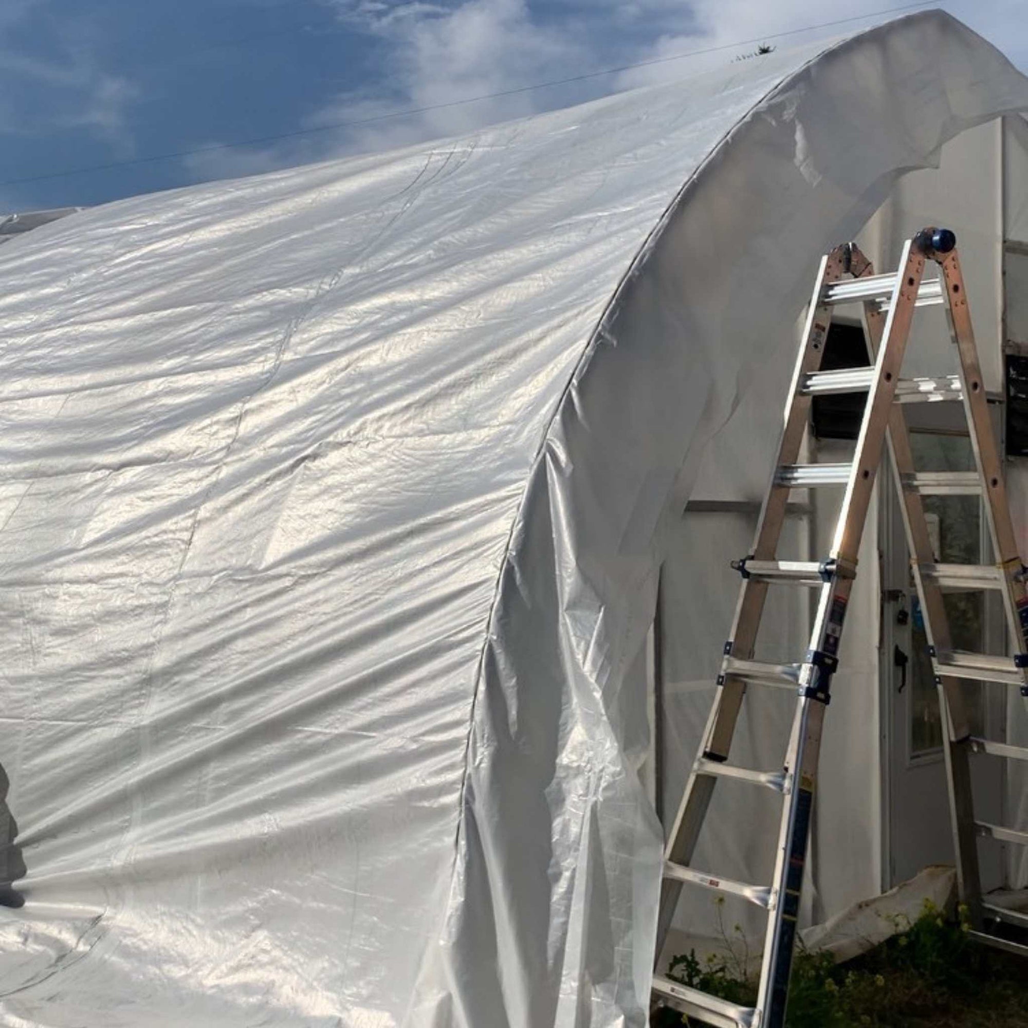 Side view of solarig plastic installed on high tunnel structure